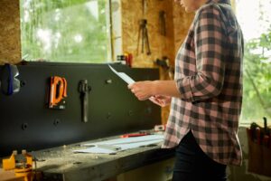 Kobieta architekt sprawdza plan nowego projektu mieszkania w warsztacie